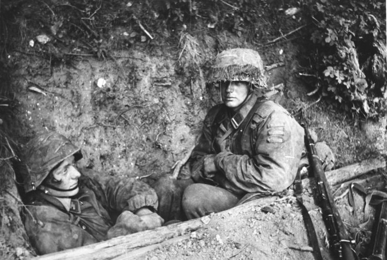 One of th soldiers has a sad look, while the other is more inexpressive. His rifle on his side