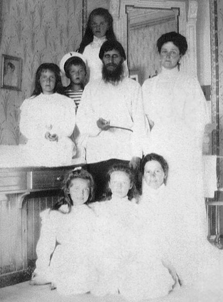 Alexandra, her daughters, the governess, and Rasputin, all dressed in white. The little Alexis is dressed as a sailor