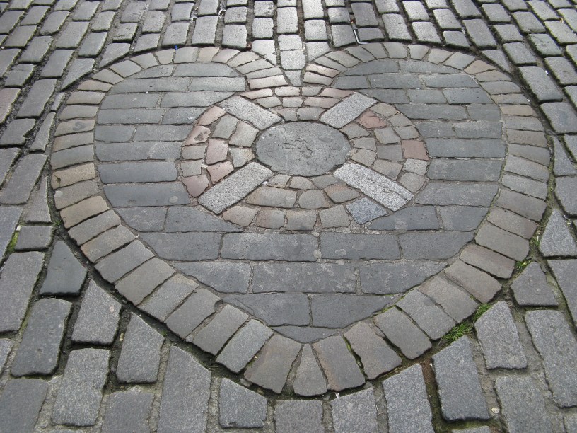 A mosaic of cobbles shaped like a heart