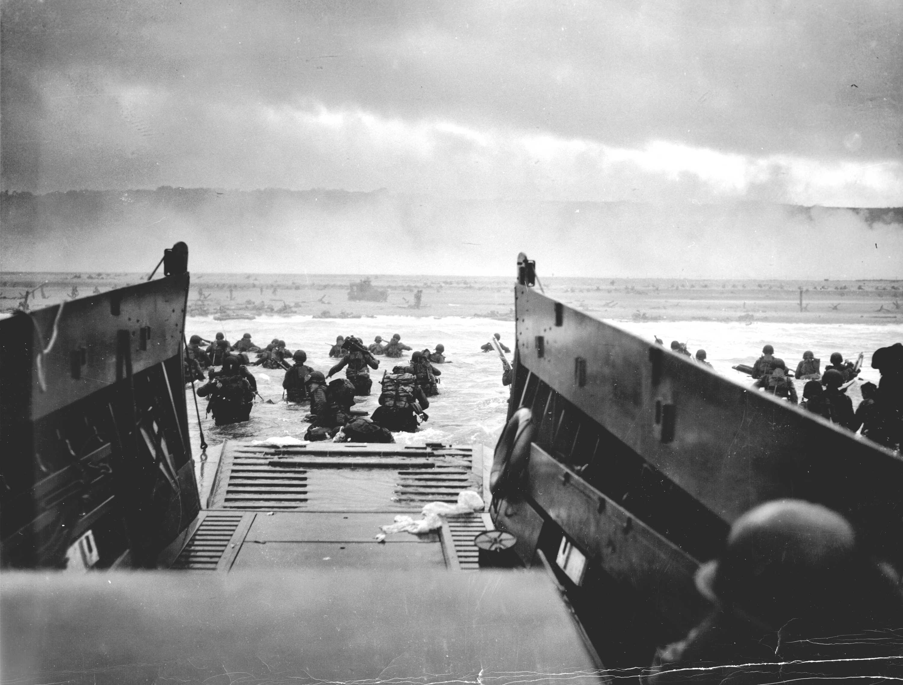 Taken from within the landing craft. The men of the Big Red One are water waist and a never-ending misty beach stretches in front of them